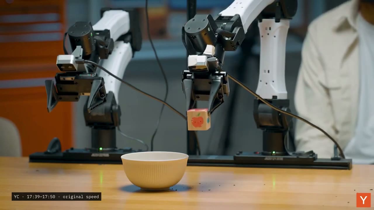 The gripper lifts the block during the source demonstration. Credit: Y Combinator.